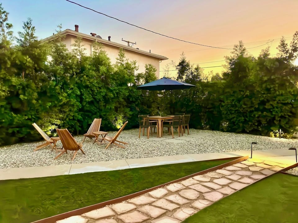 Gated large yard with hot tub, outdoor seating, propane grill, putting golf.
