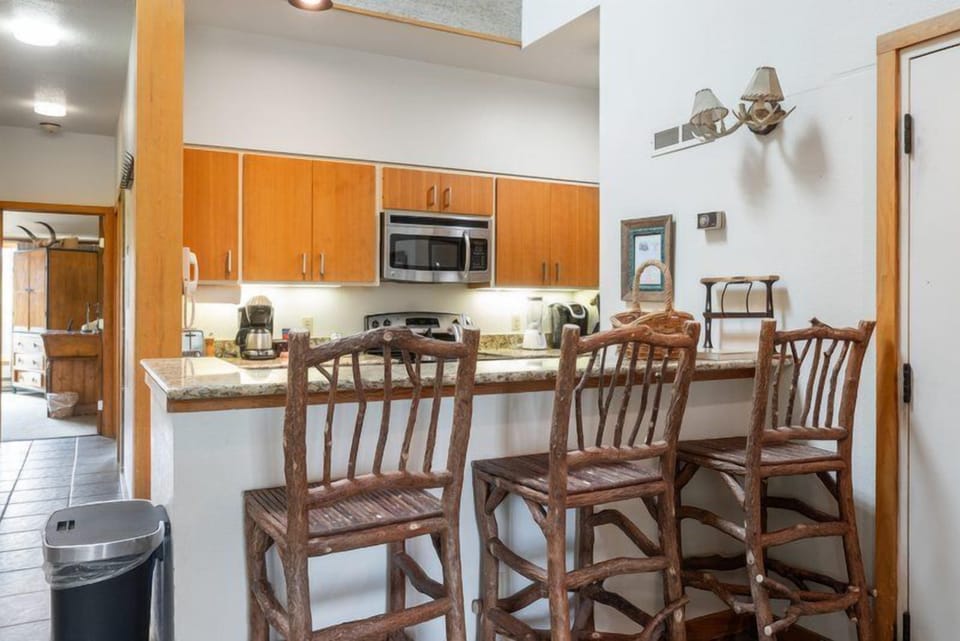 Inviting kitchen with wood finishes, bar seating, and everything you need for a home-cooked meal.