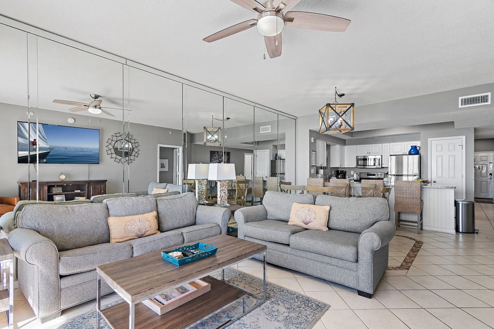 The Living space features a Queen Sleeper Sofa + Love Seat with room for the whole family, situated around a HUGE 77" Smart TV + GULF VIEWS!