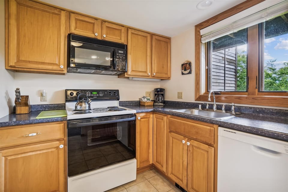 The heart of this home, the kitchen — with adjoining dining and living rooms — make it ideal for gatherings. Upgraded with plenty of counter space.