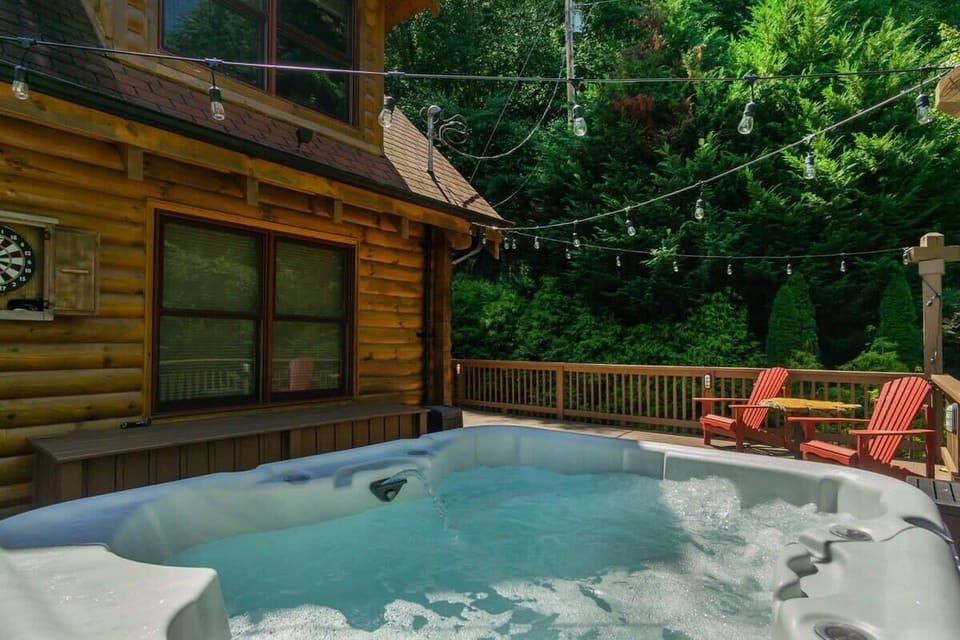 Bubbles waiting, string lights overhead, greenery all around — this hot tub spot is easy to love.