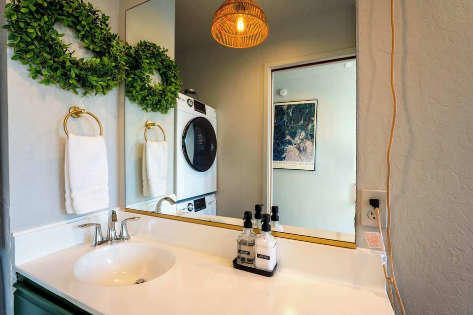Charming half bath with emerald vanity.
