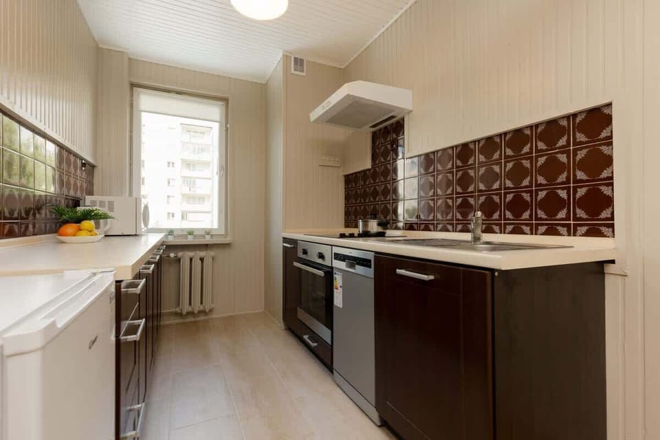 Kitchen with oven and refrigerator. 