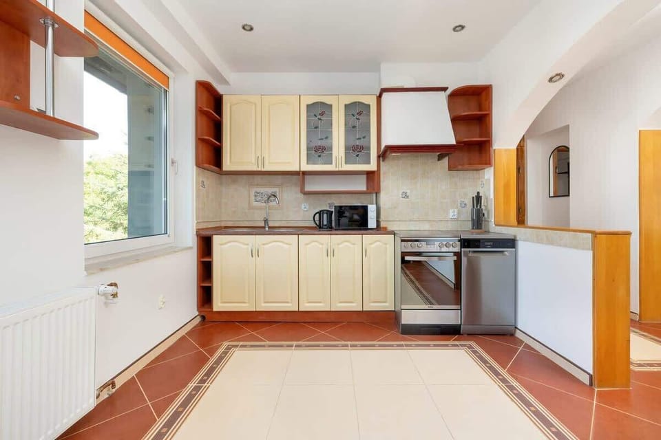 Additional kitchen perspective featuring wooden cabinetry, a built-in oven, and plenty of counter space.

