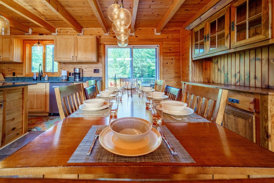 Beautiful lighting and stylish decor grace the dining room with patio doors leading to the back deck