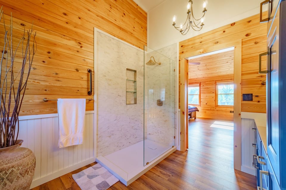 Luxuriate in our master ensuite bathroom with its 60" European walk-in shower, custom wood cabinetry, on-trend lighting and barn door leading to the bedroom