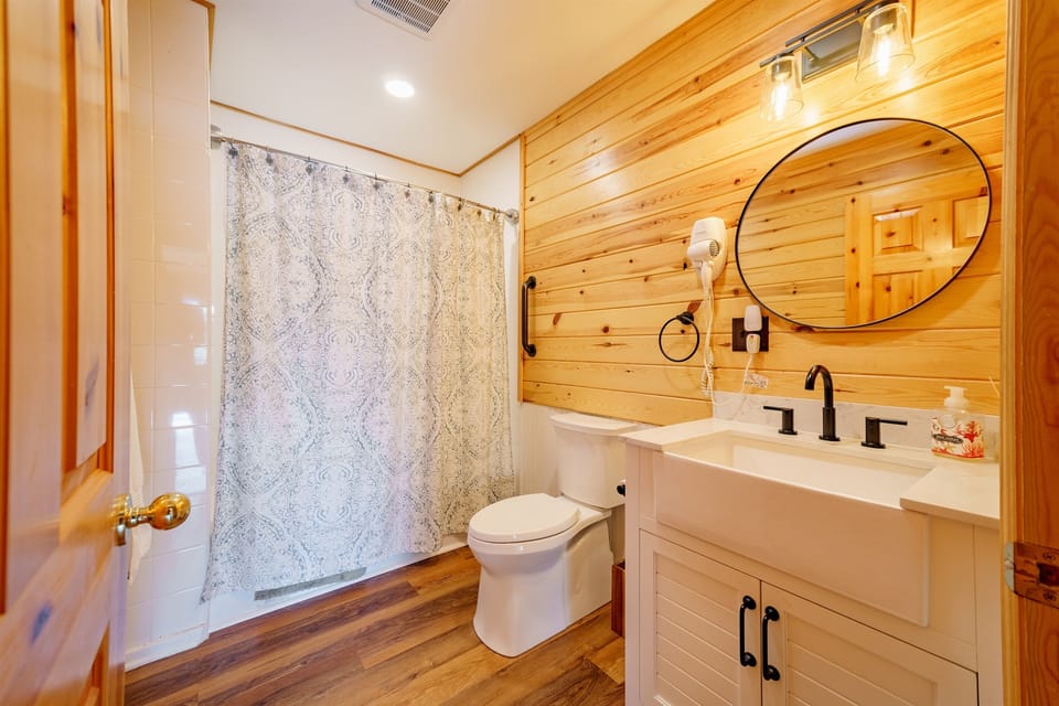 The main-floor full bathroom features a shower/tub combo, stylish lighting, and LVP flooring.