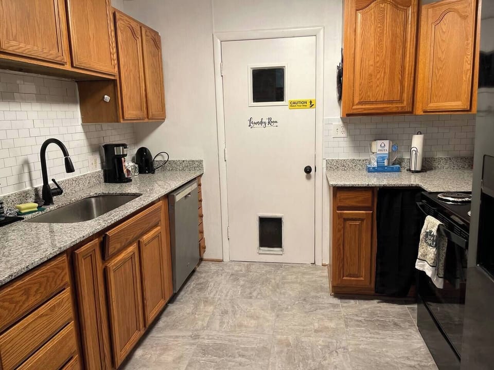 A combination pod and drip and pod coffee maker is provided along with a hot water kettle. The counters are granite and have a lot of space for meal prep. Tons of empty cabinet space for your groceries.