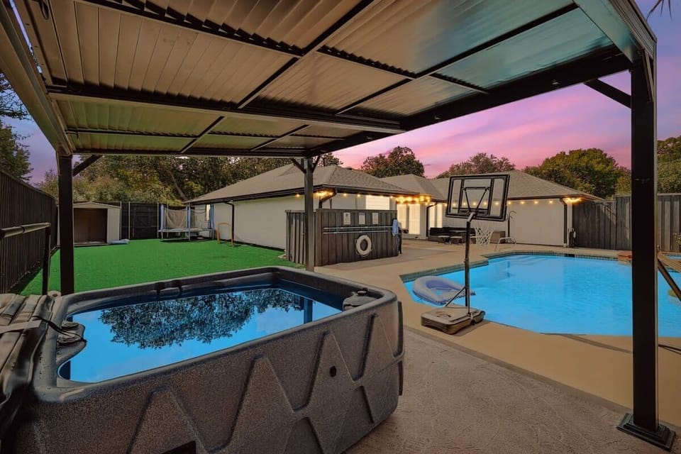 This backyard is truly an oasis unlike any other with its custom-built outdoor swimming pool, landscaped yard, and top-of-the-line jacuzzi.