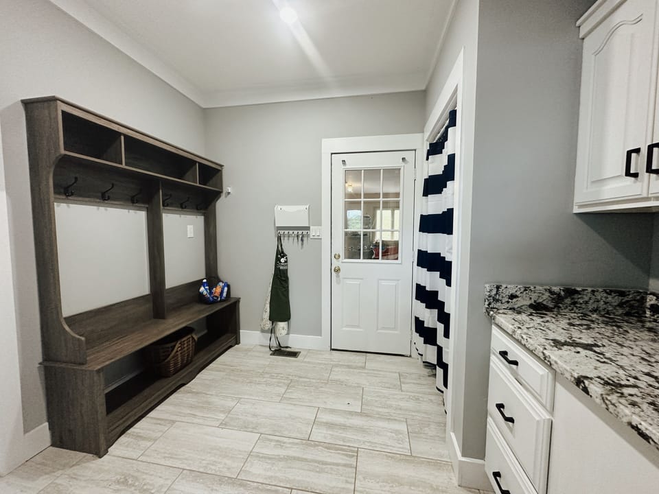 Mudroom with door to garage.  Laundry room to left.
