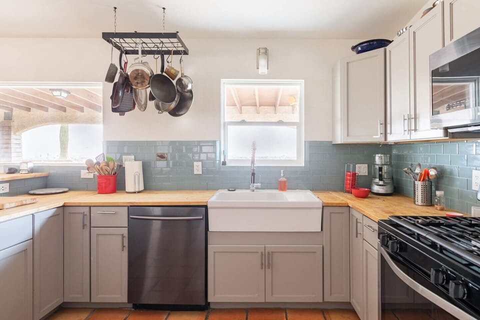 Fully equipped chef's kitchen with the patio beyond. 