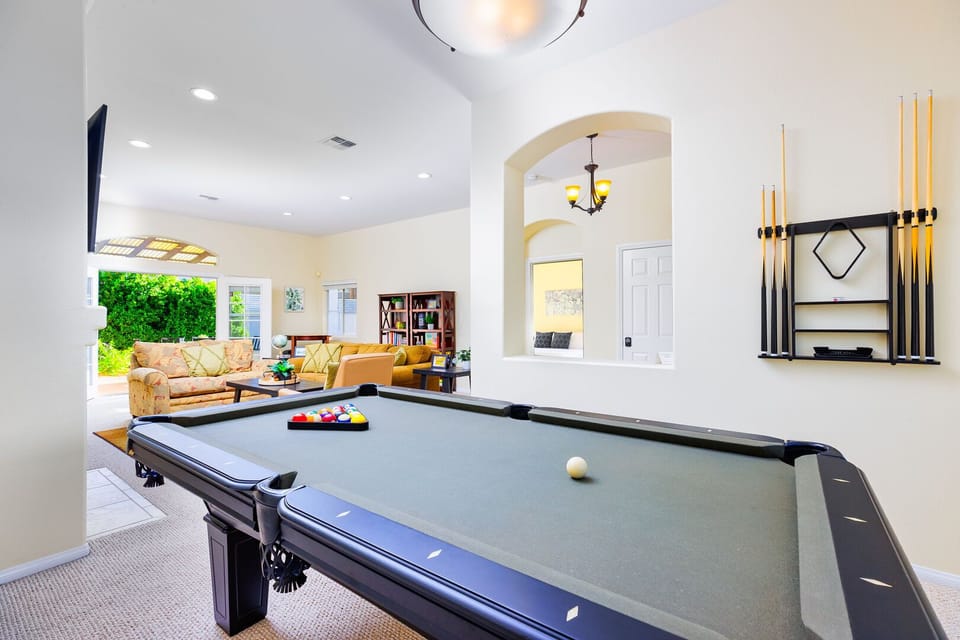 The open- living area includes a pool table, making it an ideal spot for entertaining and enjoying time with friends.