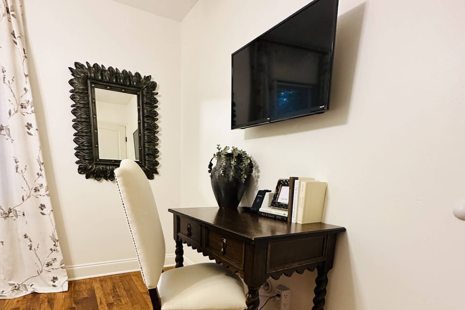 Front room with TV, charging station and Desk for your work stays
