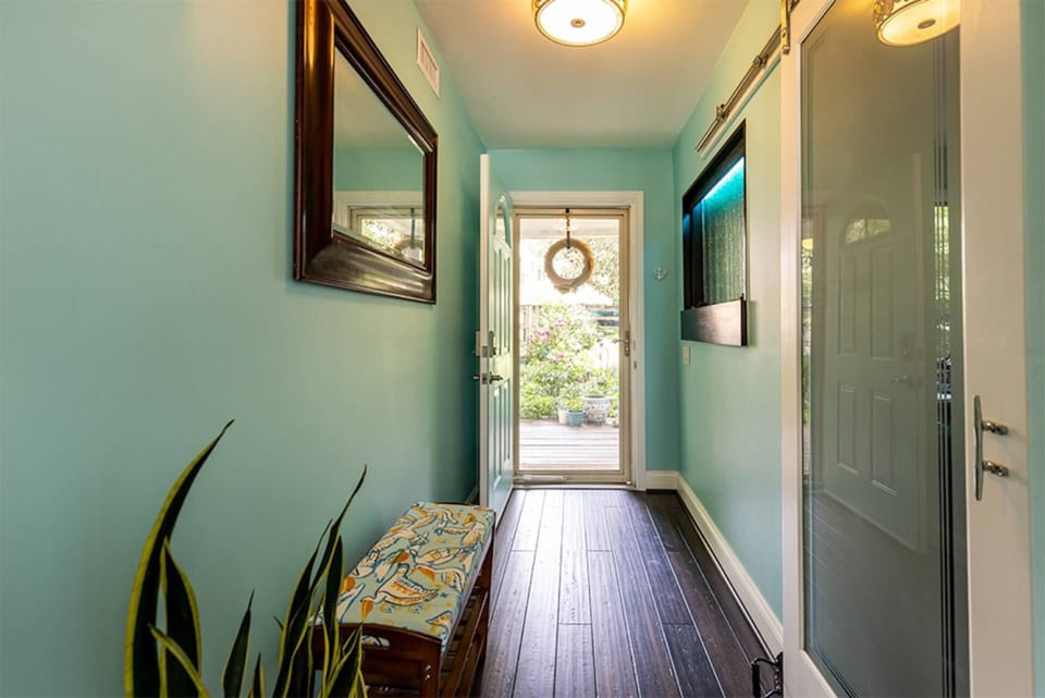 The front entrance to the home with hardwood floors throughout.
