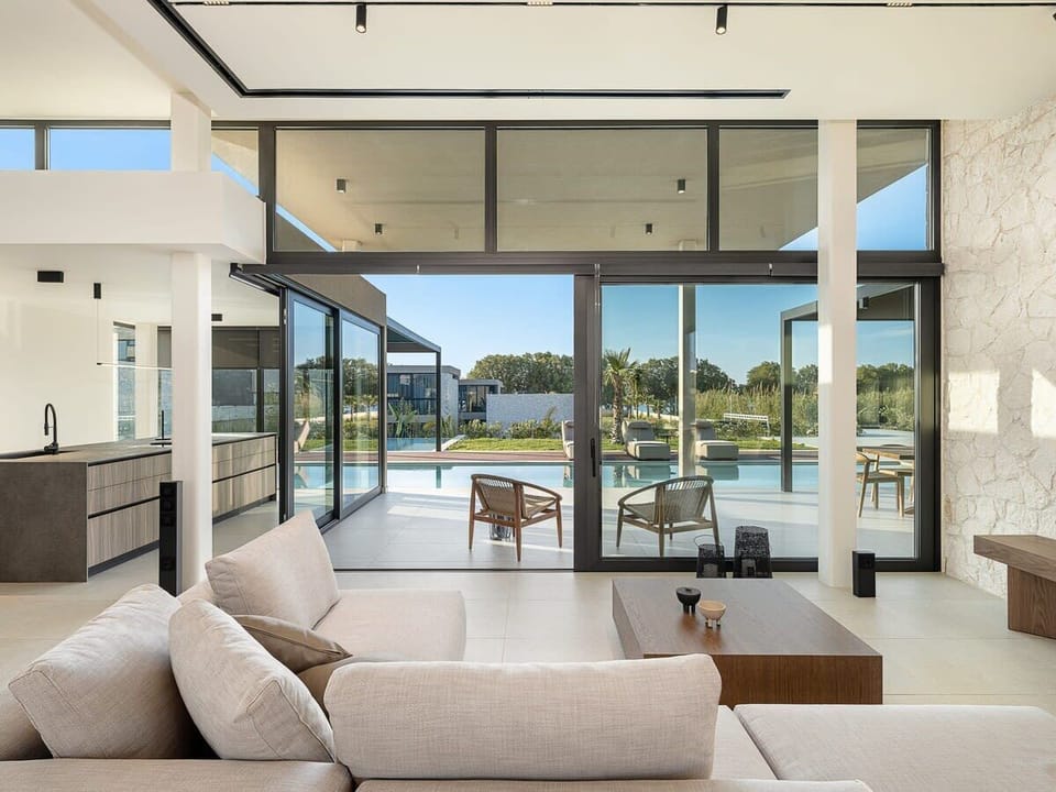Unwind on a Plush Sofa Overlooking the Pool