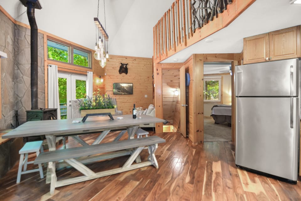 Open concept dining space and kitchen and family room with TV and fireplace