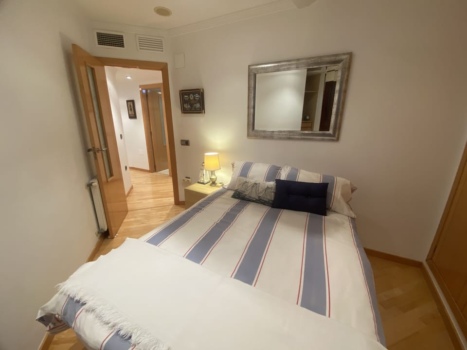 Third bedroom with full bed and view of ocean and marina
