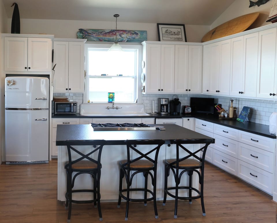 Kitchen, with bar stools to seat 3