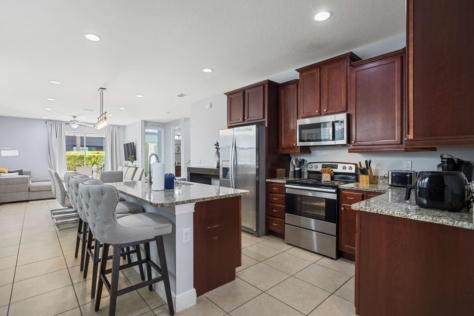 Modern kitchen with granite countertops and stainless steel appliances, perfect for cooking and entertaining.