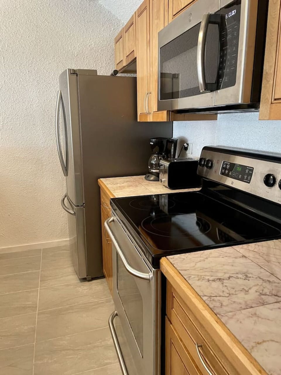 A proper kitchen with stainless steel appliances and generous counter space