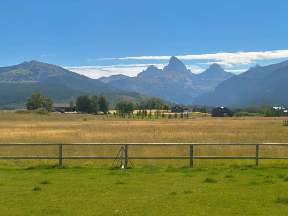 The master bedroom (located on the main level) features a king bed, an enormous en suite bathroom, and a beautiful view of the Tetons.