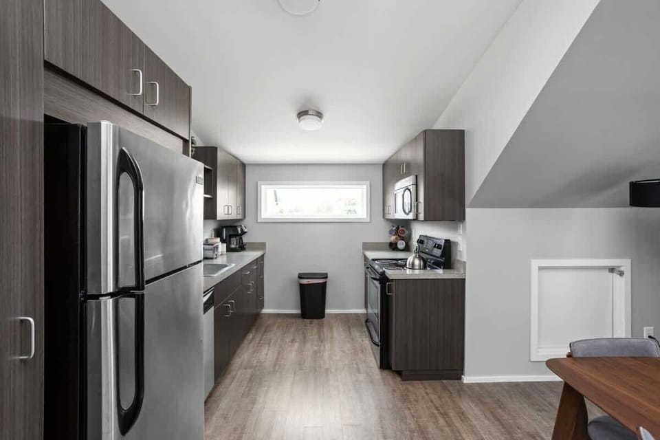 Experience our gleaming, clean kitchen, fully equipped with cooking essentials, utensils, and modern appliances for your culinary needs.