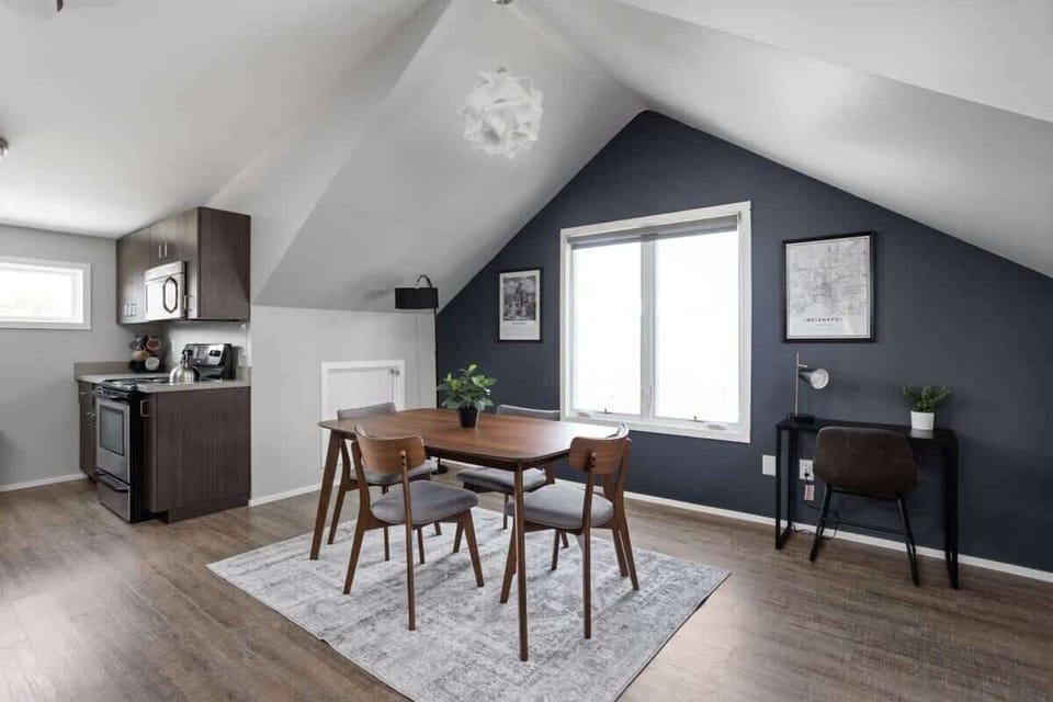 Discover our dining area, featuring a four-seating table, a window, and on the other side, a functional working table, creating a versatile and well-lit space.