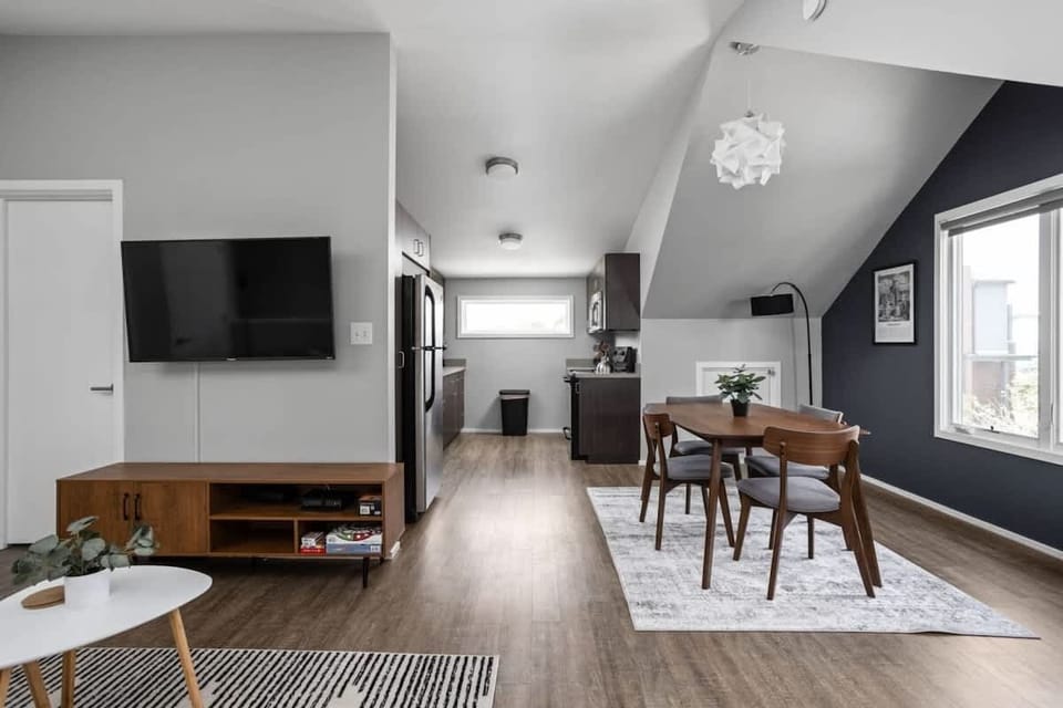 On one side, you'll find a TV, and on the right side, a four-seating dining table for your convenience.