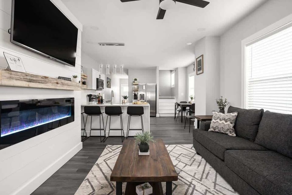 Living Room: Bright and stylish space with sleek furniture, a flickering fireplace, and vibrant decor!