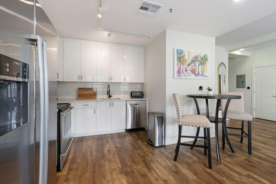 Spacious kitchen with drip coffee maker, dishes, cutlery, pots and pans.