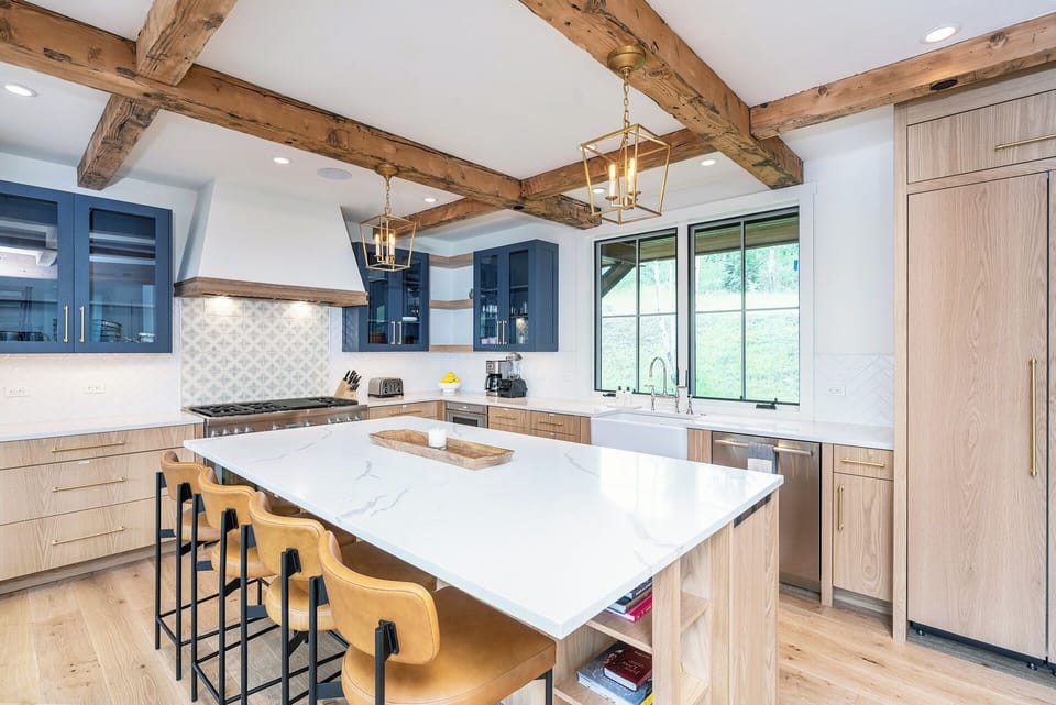 A modern chef's kitchen equipped with stainless steel appliances, a 6-burner gas stove with a griddle, and all the amenities needed to host you and your family in style.