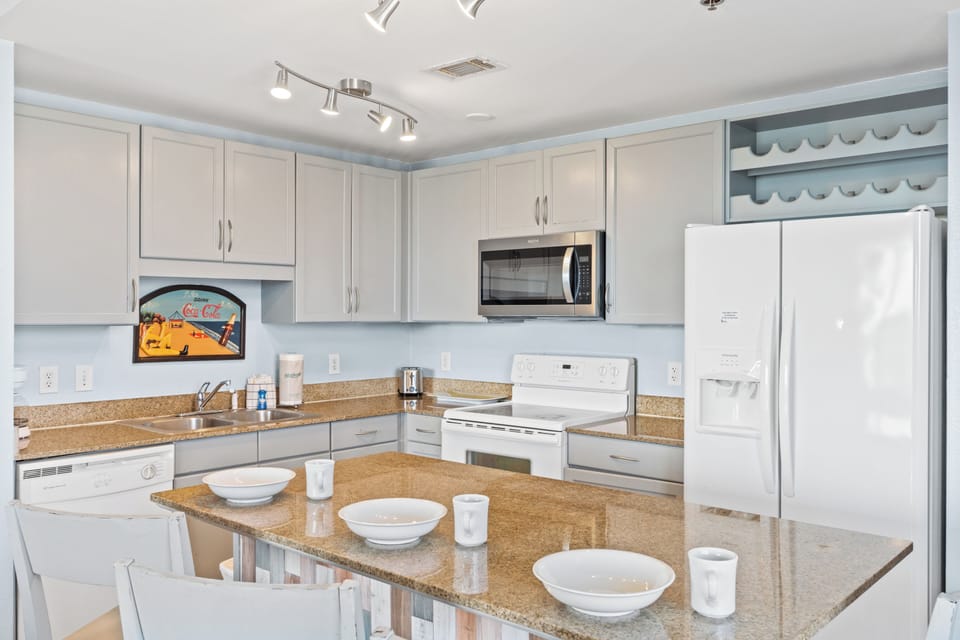 Fully Stocked Kitchen with Island Bar Seating