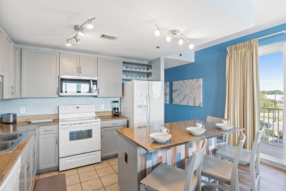 Fully Stocked Kitchen with Island Bar Seating