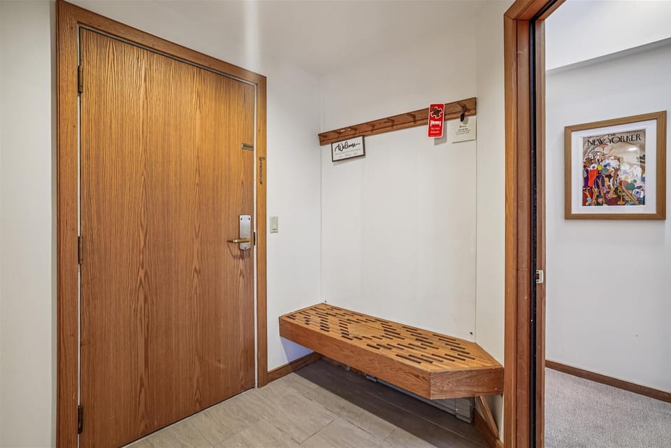 Convenient entry space with bench seating and hooks for coats and gear.