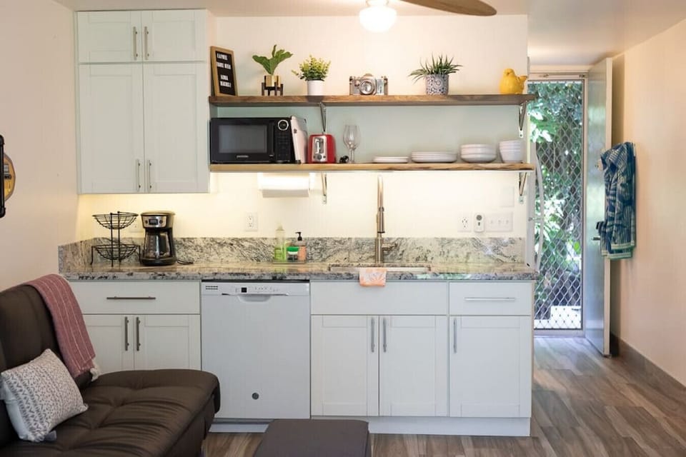 Kitchenette with full size fridge, dishwasher, microwave, coffee maker, toaster, hot plate