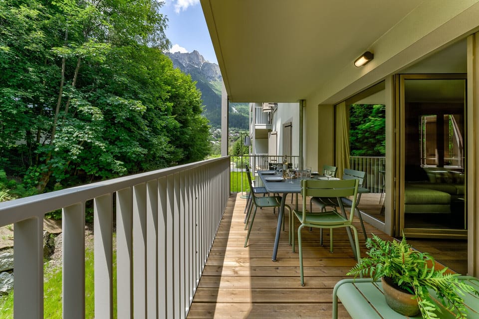 Large balcony with outdoor dining furniture