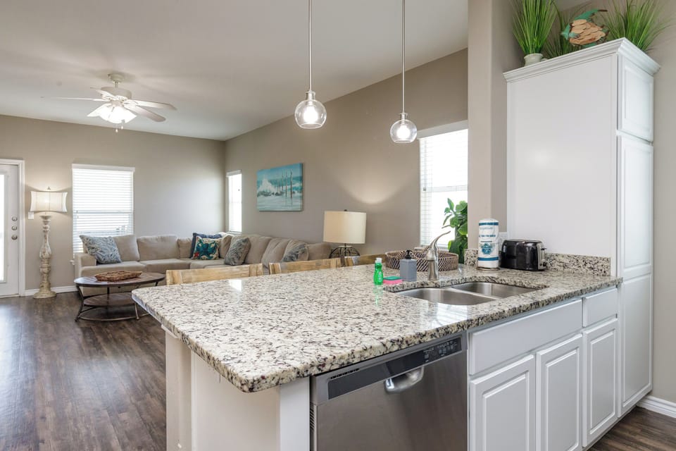 Your spacious open-concept kitchen flows seamlessly into the living area, perfect for entertaining with granite countertops and modern appliances.