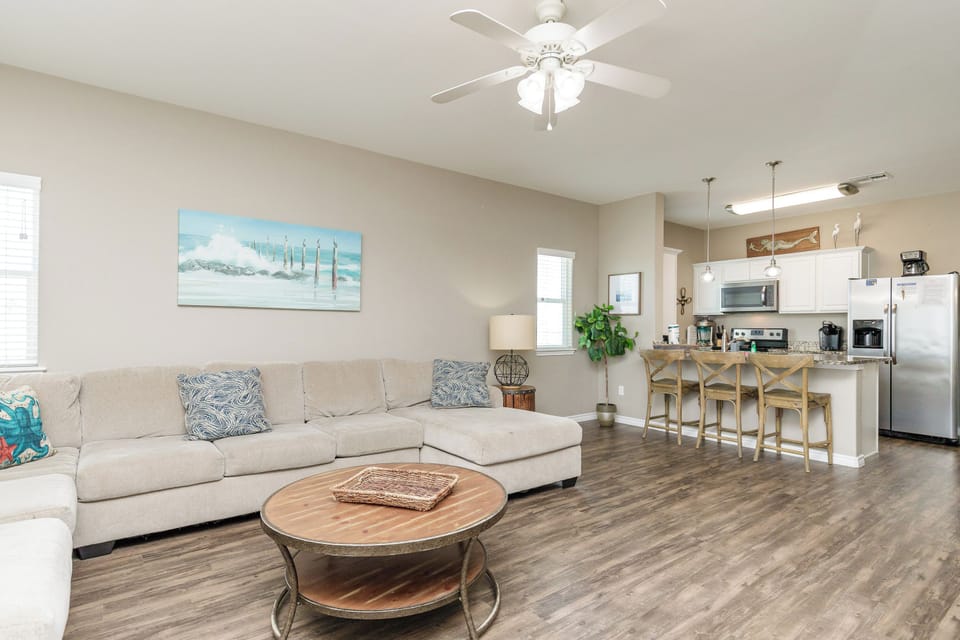 Unwind in your spacious open-plan living area with comfortable sectional seating and fully equipped kitchen—perfect for gathering with loved ones.