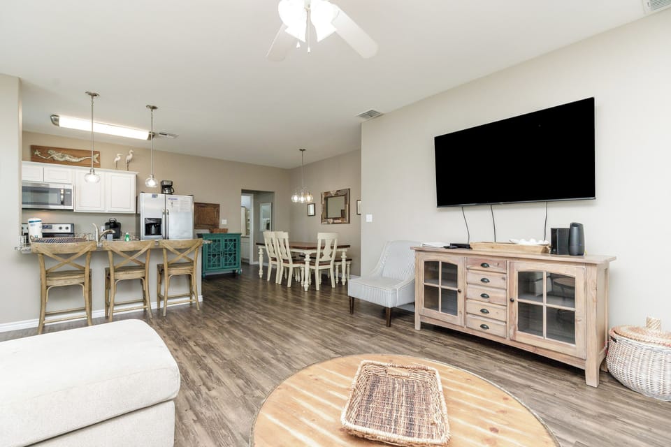 Relax in your spacious open-plan retreat where coastal charm meets modern comfort, featuring a full kitchen and cozy living area.