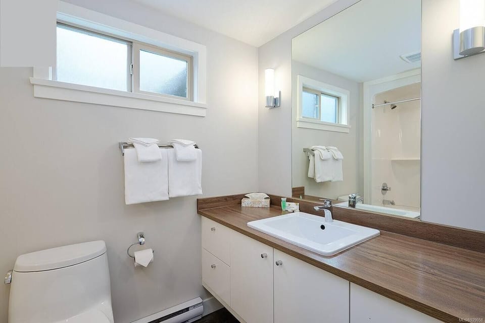 clean, crisp bathroom with tub and shower. 