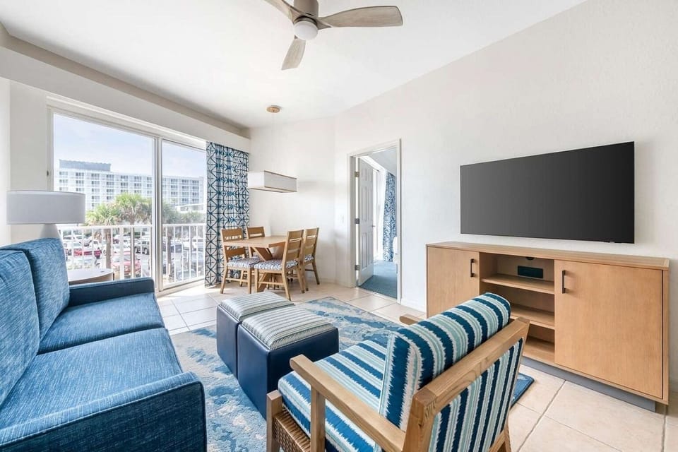 Living Area • Blue Sofa, Striped Seating & Dining Table