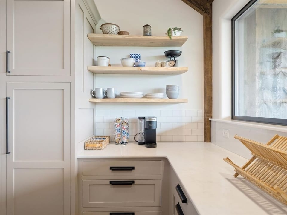 Morning beverage station with coffee, tea, cocoa, creamers, and sweetners.