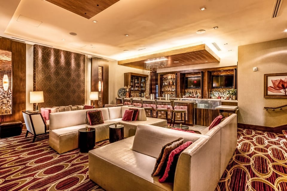 Ultra Craft Cocktails Lounge • White Sectionals, Bar & Patterned Carpet