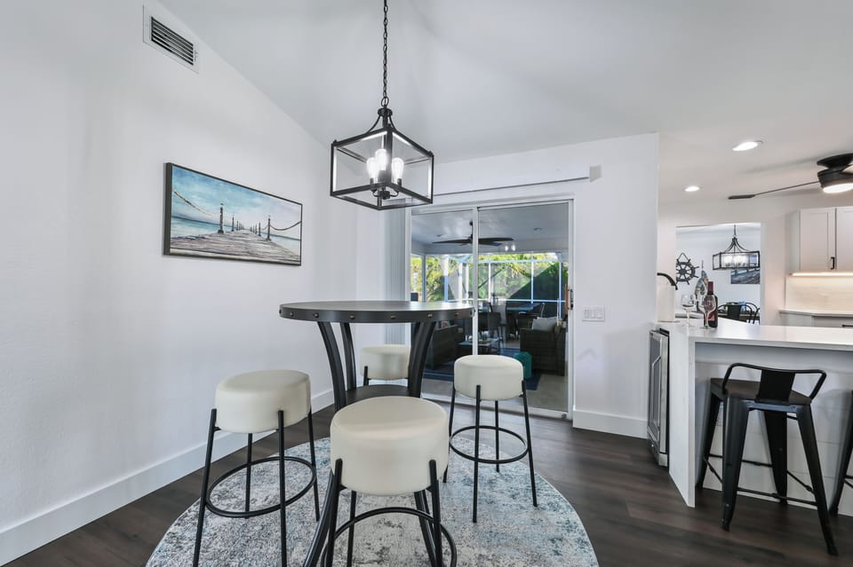 Hightop table with seating for 4 located between kitchen and family room.