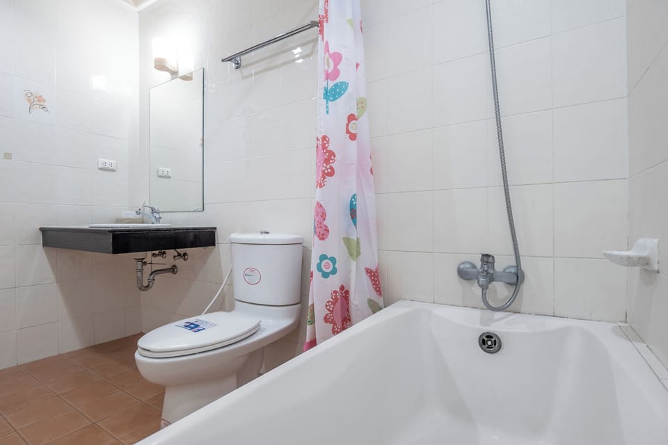 Signature Suite, 1 King Bed, Garden View | Bathroom | Shower, rainfall showerhead, designer toiletries