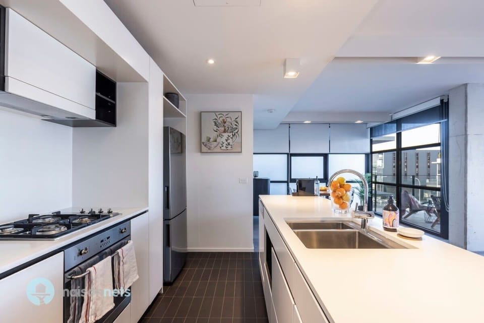 Modern appliances including dishwasher, microwave, gas stove top.