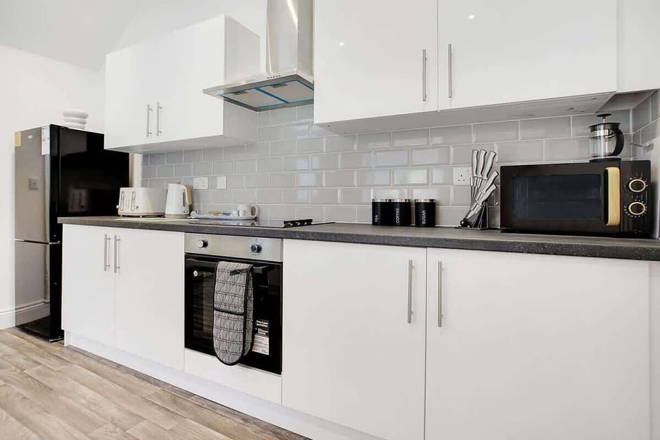 Kitchen equipped with all essentials, including a washer & dryer, oven, fridge and full cookware set.