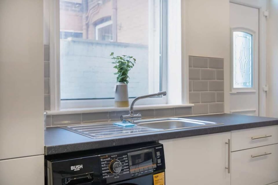 Kitchen equipped with all essentials, including a washer & dryer, oven, fridge and full cookware set.