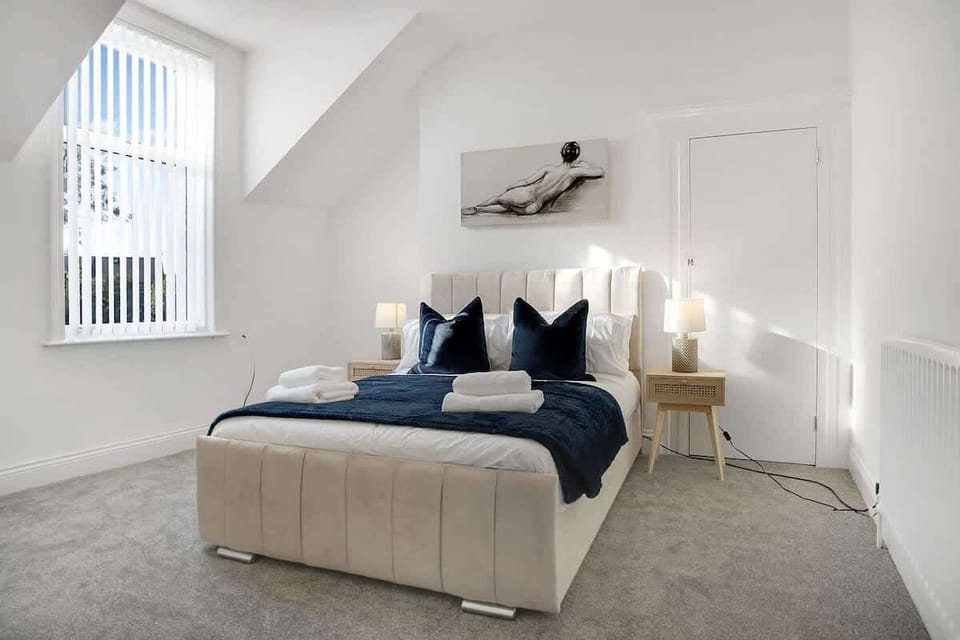 A comfortable double bed with fresh bed linen creates a welcoming space to relax and recharge after a busy day, ensuring a peaceful and restful night's sleep.