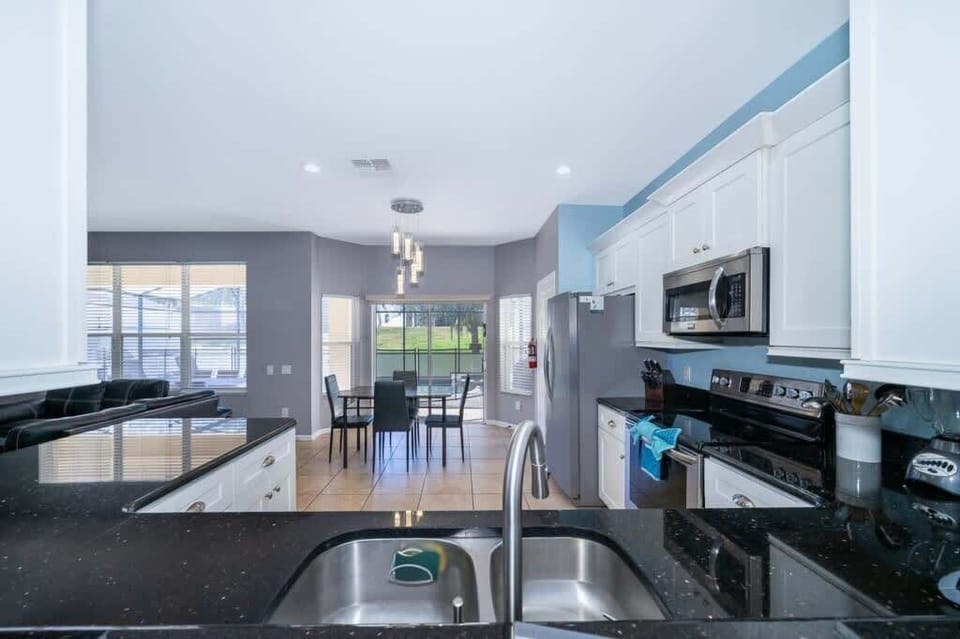Open kitchen is a modern, airy space that seamlessly blends into the living area, creating an inviting atmosphere for cooking and entertaining.